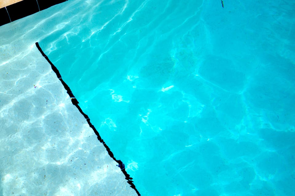 Reflection glitzes off the blue pool water.